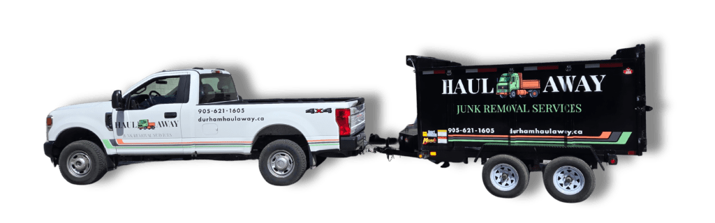 A white pickup truck with 'Haul Away' branding and a black junk removal trailer attached, showcasing contact information and services offered.